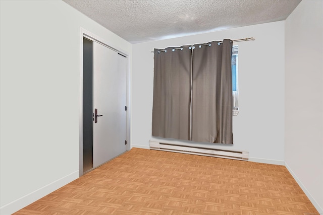 121-123 Sumac St, Waterbury, CT 06704 - unfurnished room with baseboards, a textured ceiling, and a baseboard heating unit