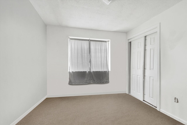 121-123 Sumac St, Waterbury, CT 06704 - unfurnished bedroom with a closet, baseboards, carpet flooring, and a textured ceiling