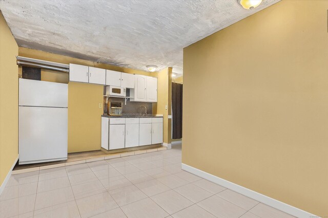 121-123 Sumac St, Waterbury, CT 06704 - kitchen with white cabinetry, a sink, baseboards, white appliances, and light tile patterned flooring