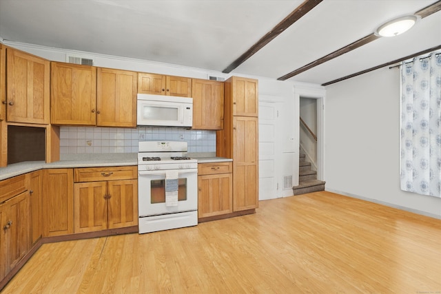 kitchen with white appliances, light countertops, light wood-type flooring, decorative backsplash, and beam ceiling