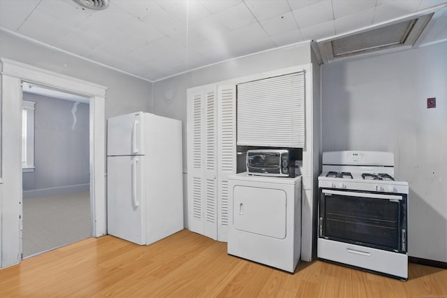 laundry area featuring washer / dryer and light wood-type flooring