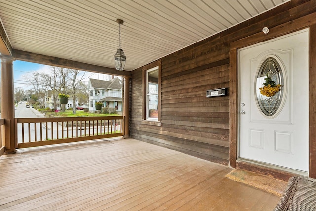 wooden terrace featuring covered porch