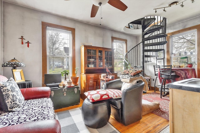 living room with stairway and a ceiling fan