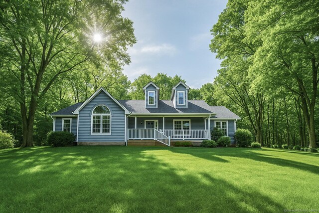 back of property featuring a lawn and covered porch