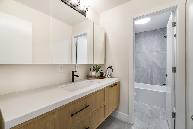 bathroom featuring shower / bathing tub combination, vanity, and baseboards