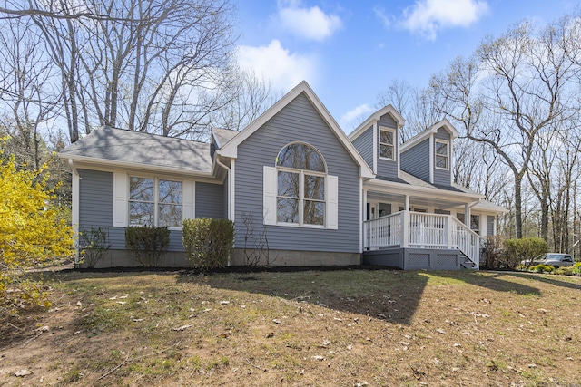 view of front facade with a porch and a shingled roof
