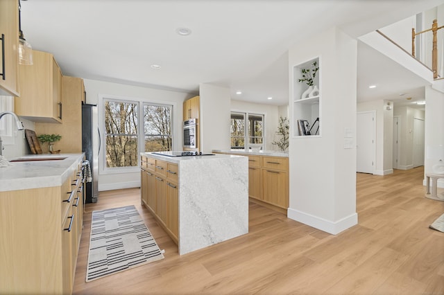 8 Goodsell Rd, Hamden, CT 06473 - kitchen featuring light brown cabinets, a sink, stainless steel appliances, light wood finished floors, and a kitchen island