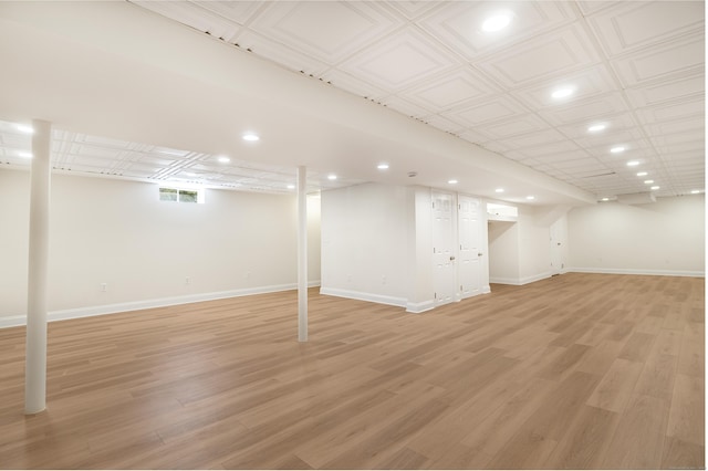 basement featuring recessed lighting, visible vents, light wood-style flooring, and baseboards