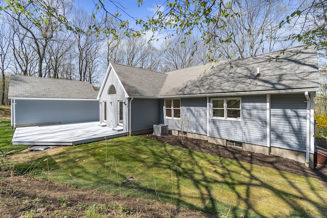 rear view of house featuring roof with shingles, central AC unit, a yard, and a wooden deck