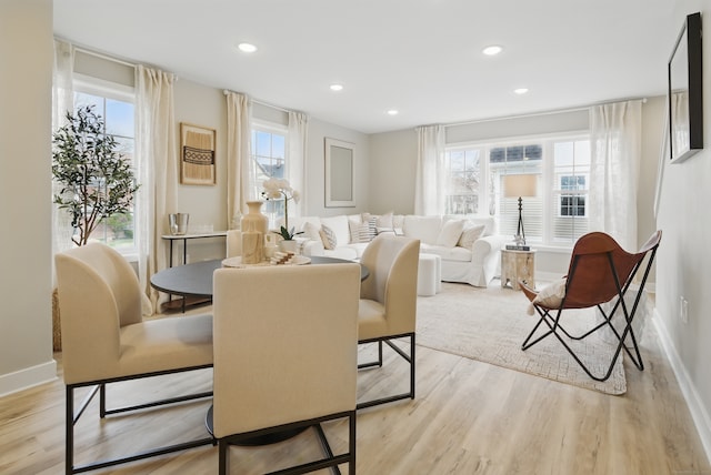 dining space with recessed lighting, plenty of natural light, light wood-type flooring, and baseboards