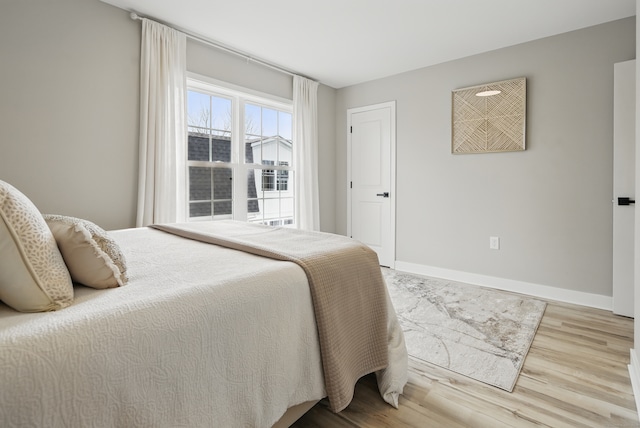 bedroom with wood finished floors and baseboards
