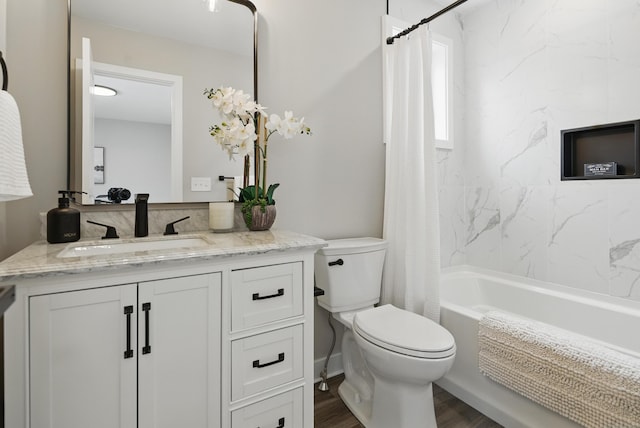 bathroom featuring shower / bath combination with curtain, vanity, toilet, and wood finished floors
