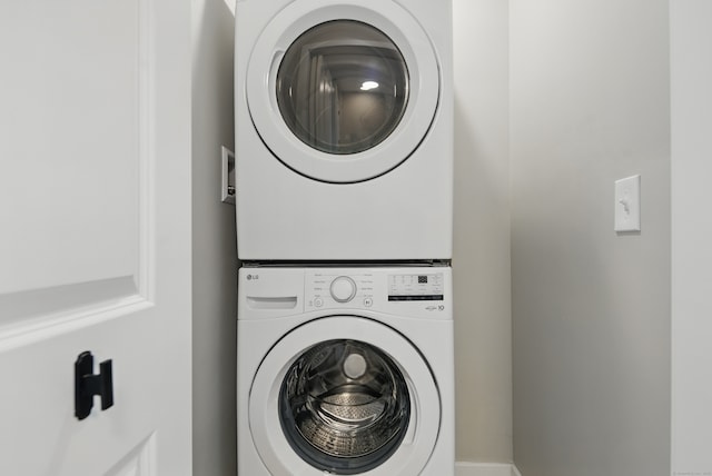 washroom featuring stacked washing maching and dryer and laundry area