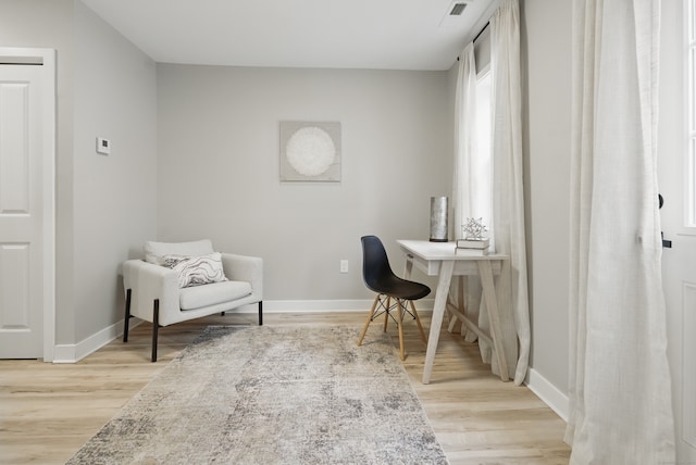 office space with light wood-style flooring and baseboards