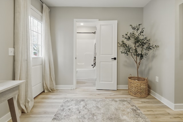 entryway featuring light wood-style floors and baseboards