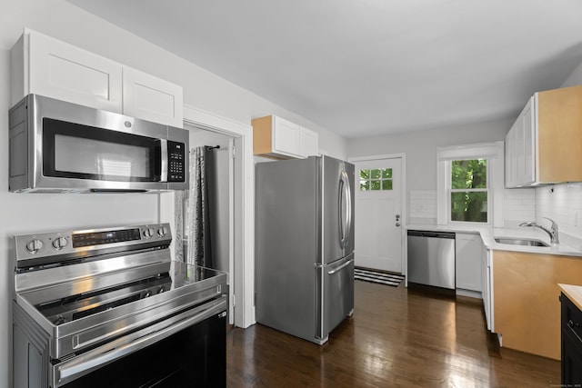 4 Glynn Ave, Middletown, CT 06457 - kitchen with appliances with stainless steel finishes, a sink, dark wood-style flooring, backsplash, and white cabinets