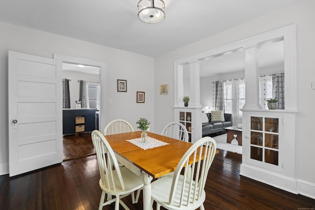 4 Glynn Ave, Middletown, CT 06457 - dining room featuring decorative columns, dark wood-style floors, and baseboards