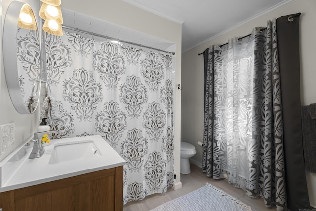 4 Glynn Ave, Middletown, CT 06457 - bathroom with wood finished floors, vanity, toilet, and ornamental molding