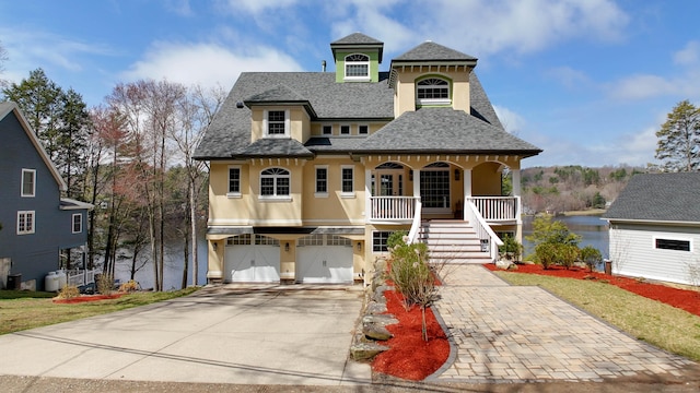 72 Indian Spring Rd, Woodstock, CT 06281 - view of front of home featuring stairway, a shingled roof, covered porch, driveway, and stucco siding