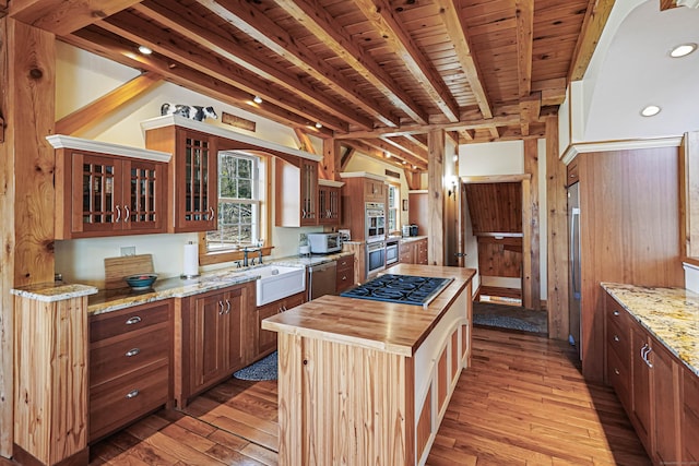 72 Indian Spring Rd, Woodstock, CT 06281 - kitchen with beamed ceiling, a sink, appliances with stainless steel finishes, light wood-style floors, and butcher block counters