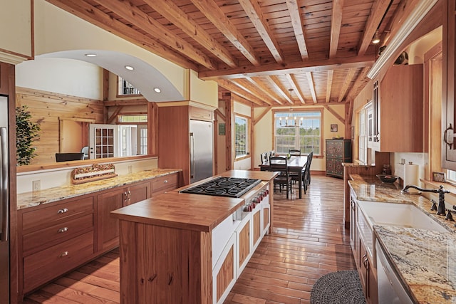 72 Indian Spring Rd, Woodstock, CT 06281 - kitchen featuring butcher block countertops, beam ceiling, stainless steel appliances, light wood-type flooring, and a kitchen island