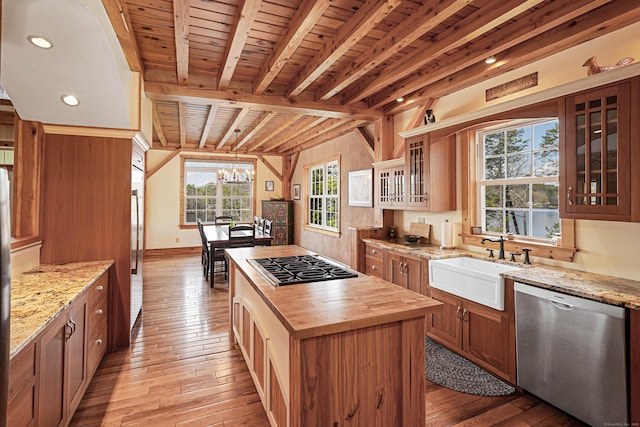 72 Indian Spring Rd, Woodstock, CT 06281 - kitchen with butcher block counters, appliances with stainless steel finishes, light wood finished floors, a sink, and a center island
