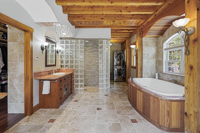 72 Indian Spring Rd, Woodstock, CT 06281 - bathroom featuring beam ceiling, vanity, a bath, wood ceiling, and stacked washer and dryer