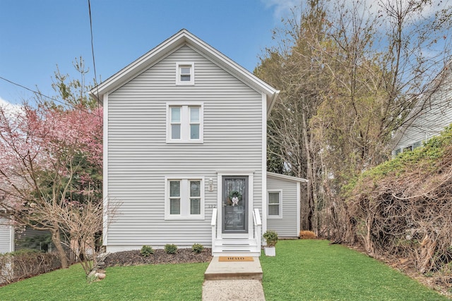 traditional-style house with a front lawn