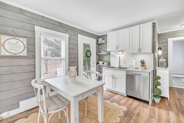 kitchen with dishwasher, a baseboard radiator, crown molding, and a sink