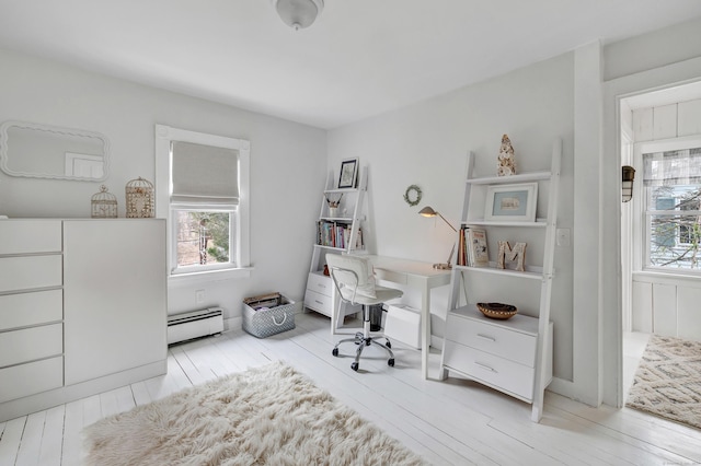 office featuring a baseboard radiator and wood finished floors