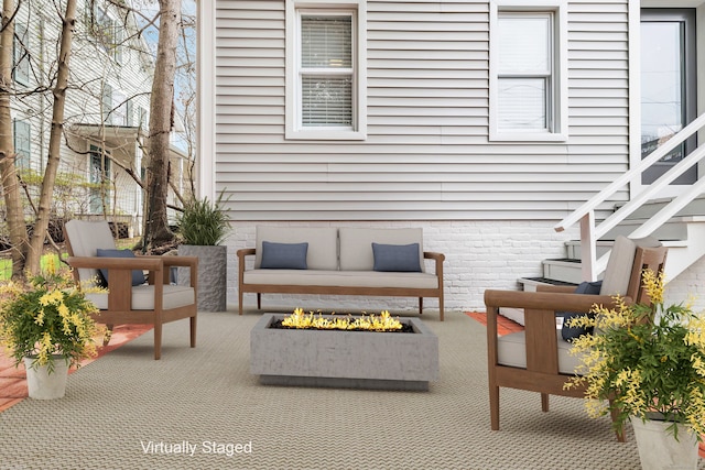 view of patio with stairs and an outdoor fire pit