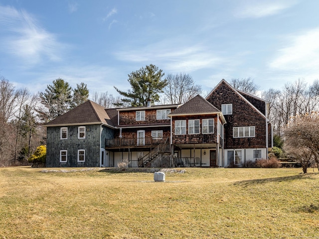 back of house with stairway, a wooden deck, and a lawn