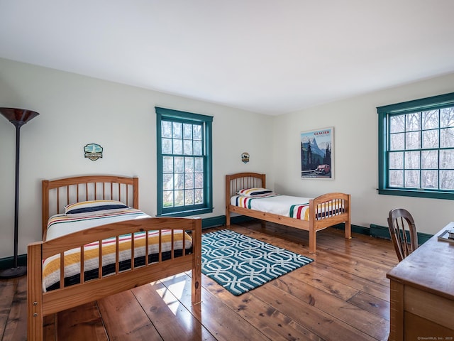 bedroom with baseboards and hardwood / wood-style floors