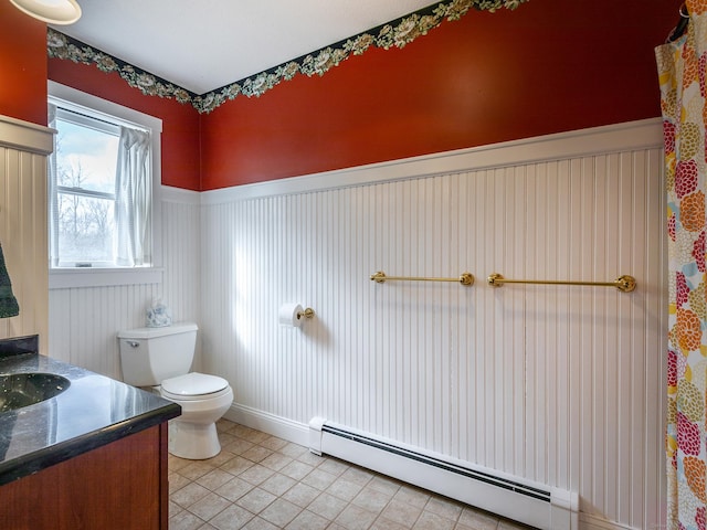 bathroom with vanity, tile patterned flooring, a wainscoted wall, toilet, and a baseboard radiator