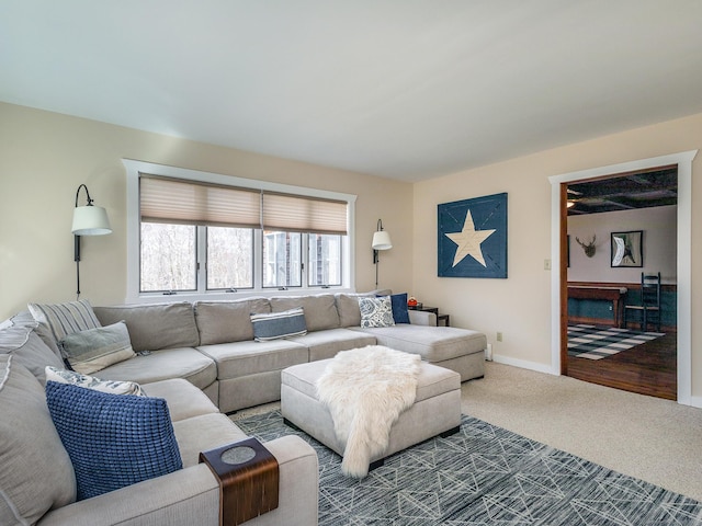 living area with baseboards and carpet floors