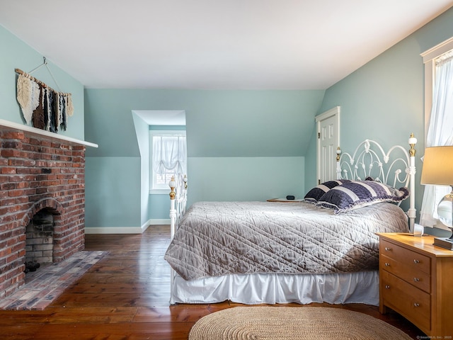 bedroom featuring multiple windows, hardwood / wood-style flooring, baseboards, and lofted ceiling