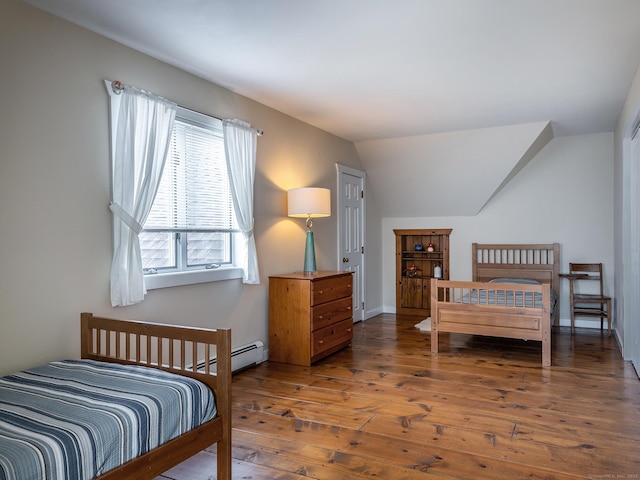 bedroom featuring wood-type flooring, baseboards, lofted ceiling, and baseboard heating