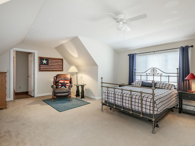 carpeted bedroom with baseboards, vaulted ceiling, and a ceiling fan