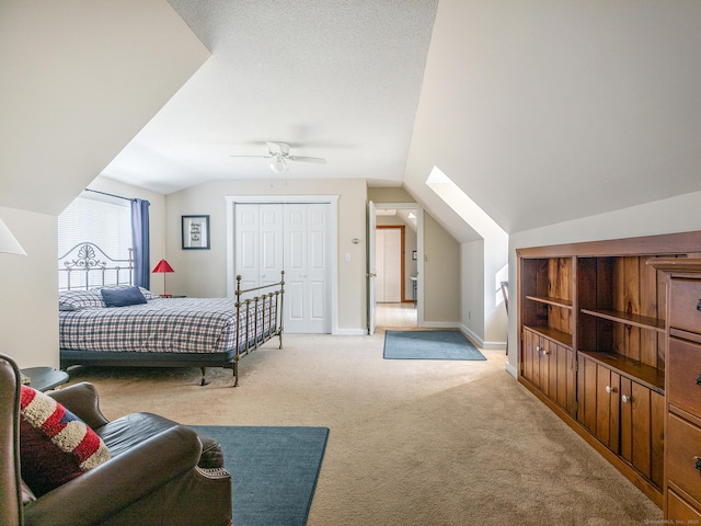 bedroom featuring light carpet, ceiling fan, baseboards, and lofted ceiling