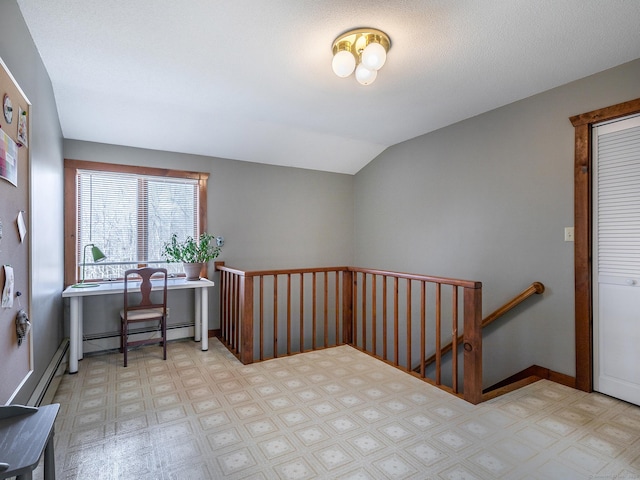 office area featuring a baseboard radiator, baseboards, lofted ceiling, and tile patterned floors