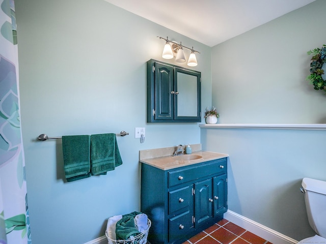 bathroom featuring tile patterned floors, toilet, vanity, and baseboards