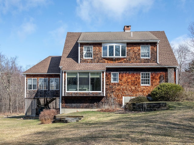 rear view of property featuring a sunroom, a yard, roof with shingles, stairs, and a chimney