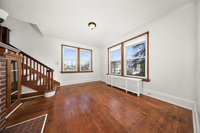 639 Cooke St, Waterbury, CT 06710 - interior space featuring baseboards, stairway, crown molding, radiator heating unit, and hardwood / wood-style flooring