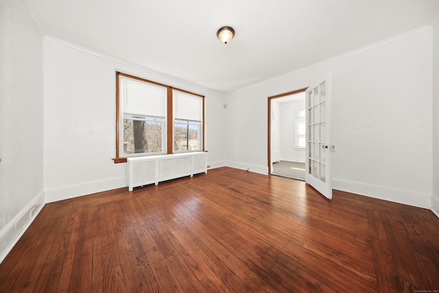 639 Cooke St, Waterbury, CT 06710 - empty room featuring wood-type flooring, radiator heating unit, and a healthy amount of sunlight