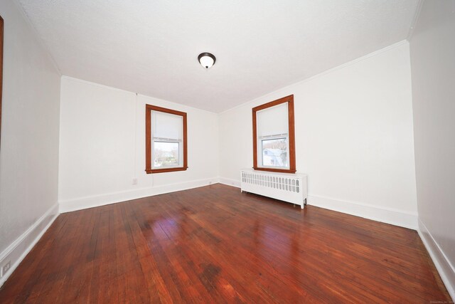 639 Cooke St, Waterbury, CT 06710 - unfurnished room featuring crown molding, radiator, baseboards, and dark wood finished floors