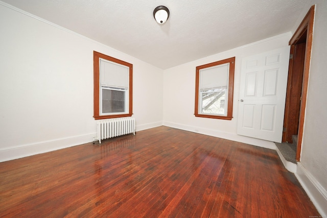 639 Cooke St, Waterbury, CT 06710 - unfurnished room featuring a textured ceiling, radiator, baseboards, and dark wood-style floors