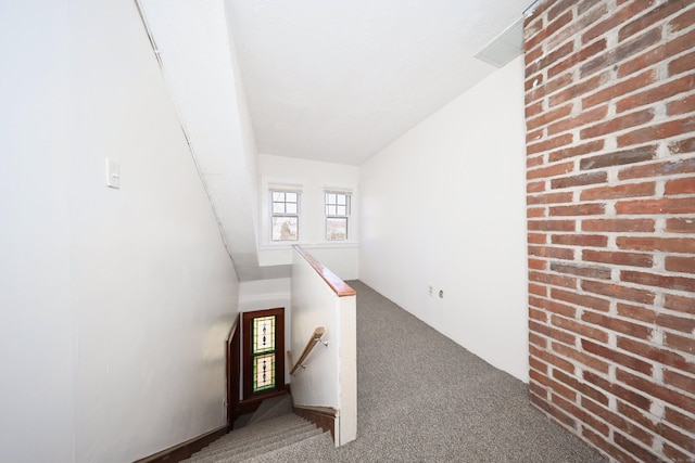639 Cooke St, Waterbury, CT 06710 - interior space with brick wall, carpet, and an upstairs landing