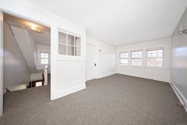 639 Cooke St, Waterbury, CT 06710 - interior space featuring dark colored carpet, baseboards, and a textured ceiling
