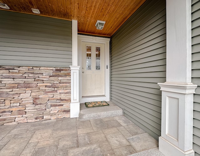 property entrance with stone siding