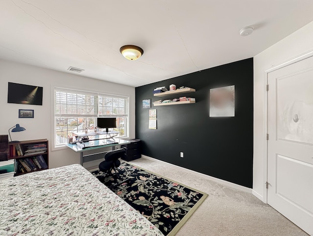 carpeted office space with visible vents and baseboards